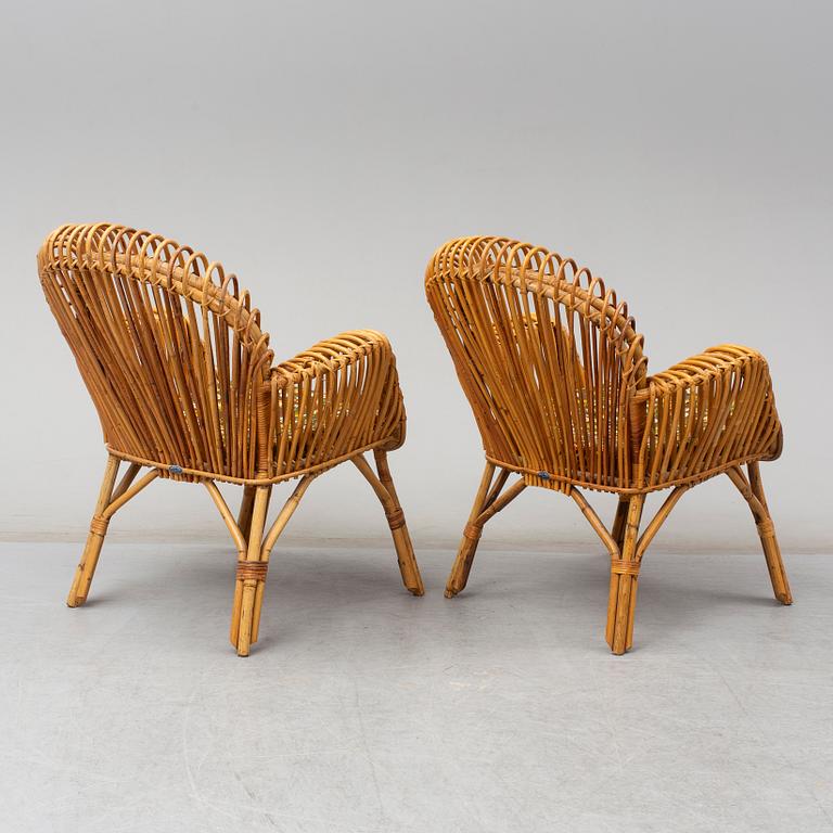 A pair of rattan armchairs, Emilio Paoli, via Vigna Nuova, 8, Firenze, Italy, second half of the 20th century. Signed.
