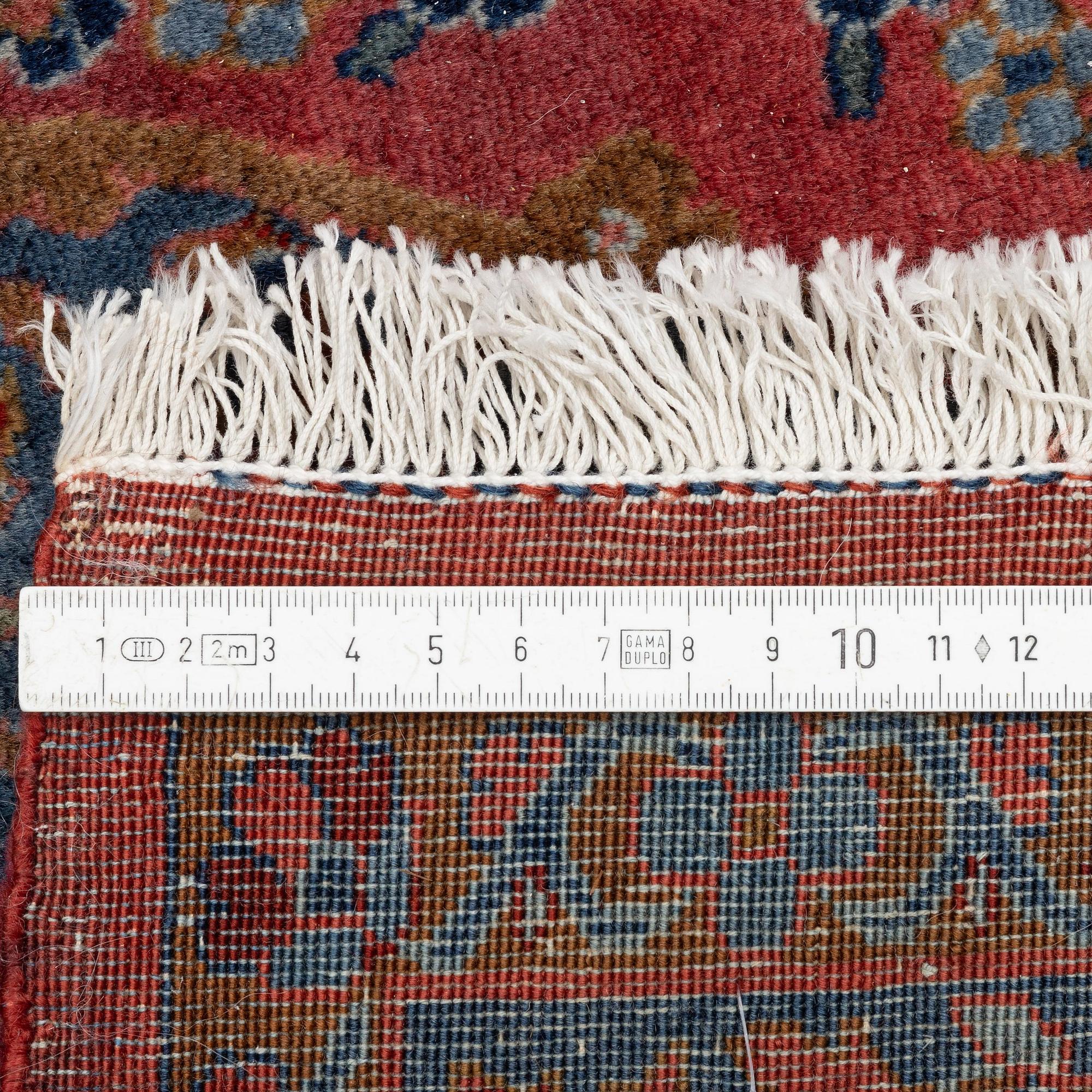An antique Manchester Kashan rug, c. 197 x 126 cm.