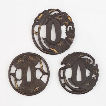 Three iron tsuba with gold inlay, two signed, Edo period.