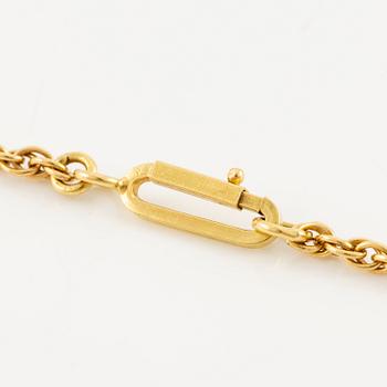 An Andrew Grima pendant in 18K gold set with step-cut emeralds, rubies and round brilliant-cut diamonds.