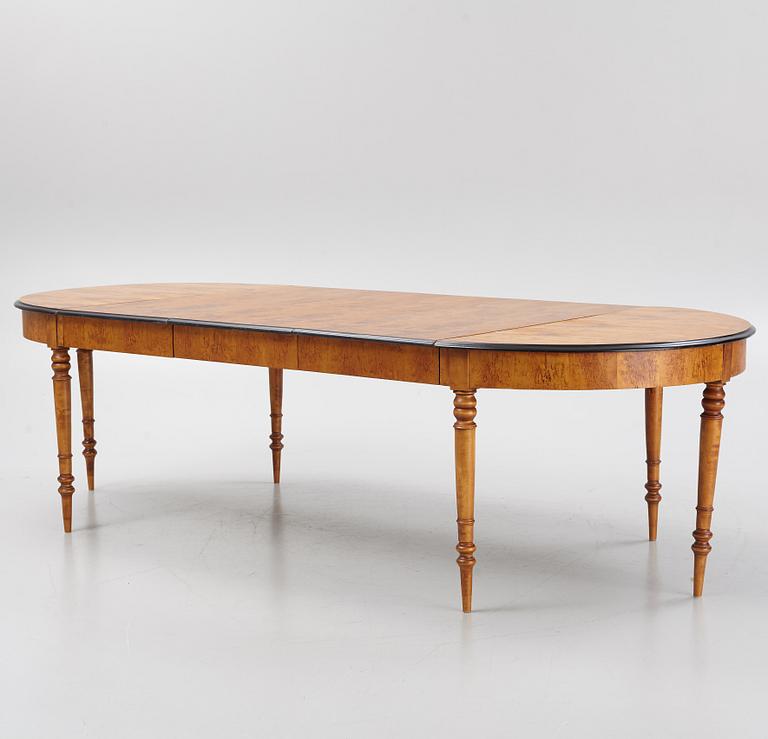 A birch veneered dining table, second half of the 19th Century.