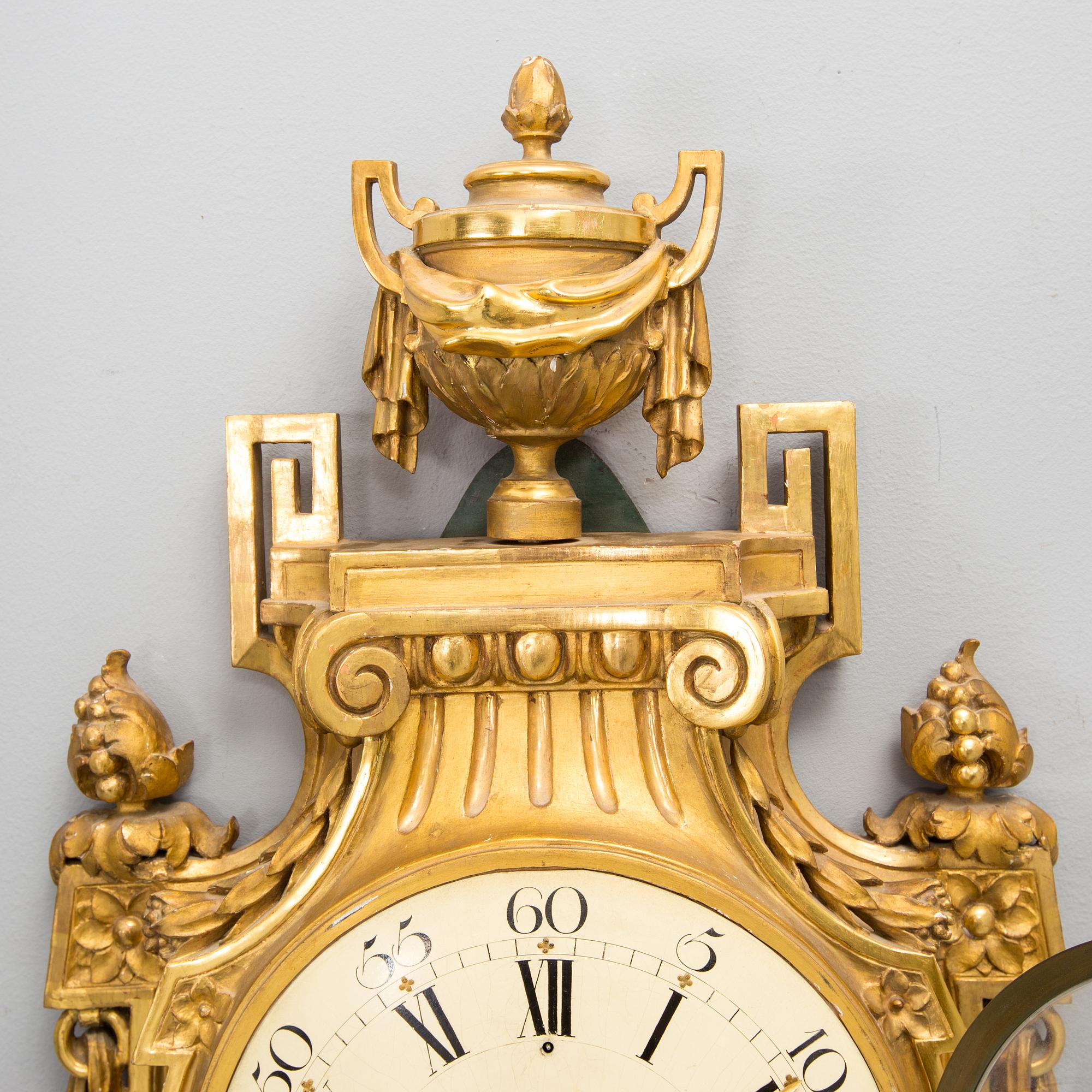 A wall clock in gustavian style, marked Rob. Engström, Stockholm.