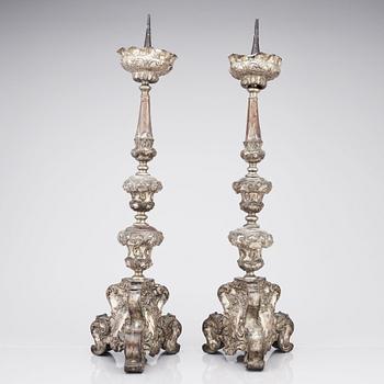 A pair of argente haché Baroque floor candlesticks, presumably Italy 18th century.