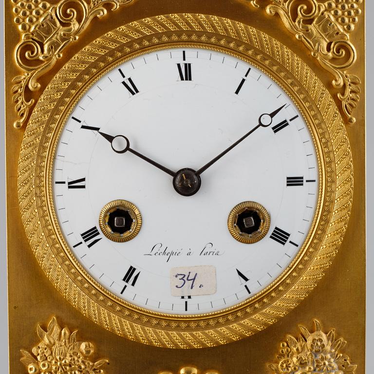 A French Empire gilt bronze mantel clock.