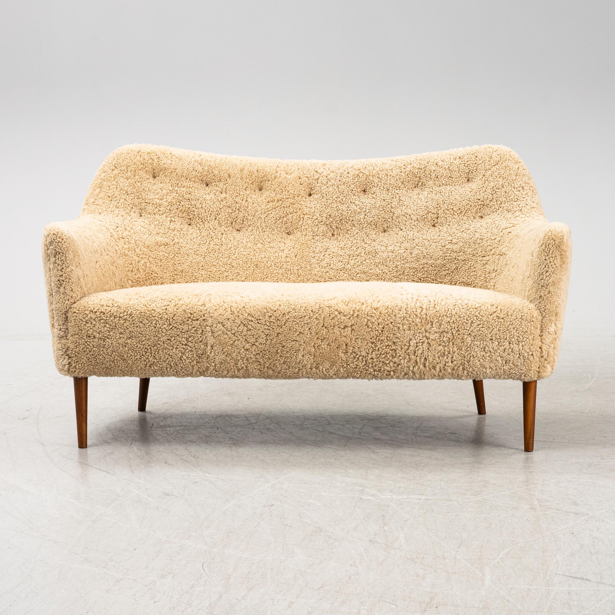 A mid 20th Century sofa with teak legs and new sheepskin upholstery, possibly by Carl Brorup, Slagelse, Denmark.