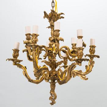 A late 19th-century 12-arm bronze chandelier.