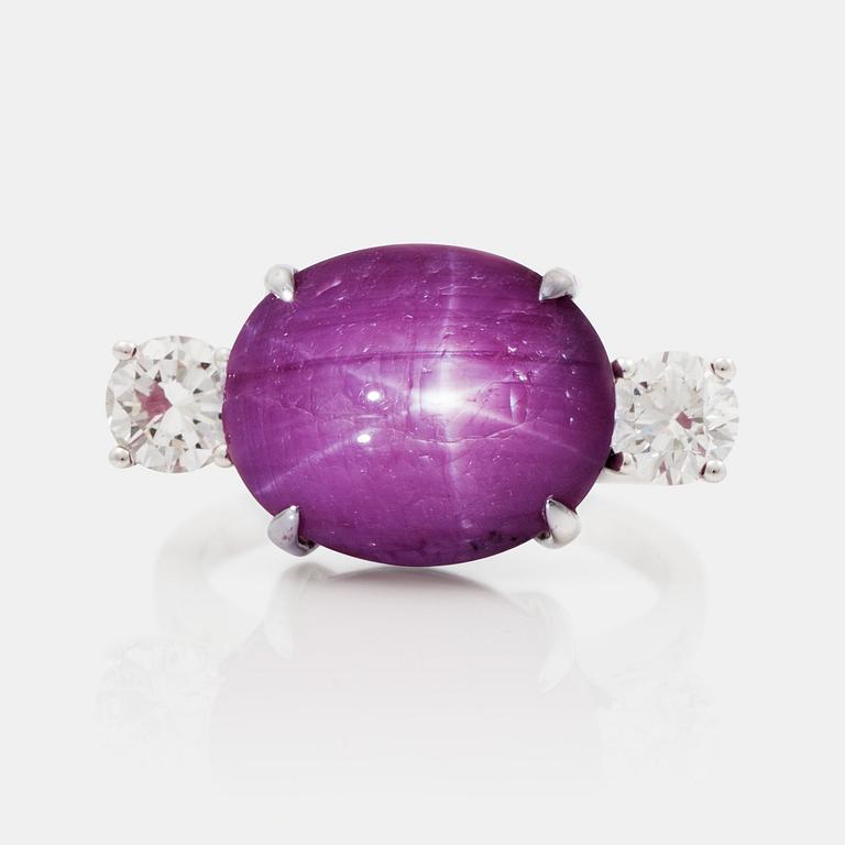 A cabochon cut star ruby and brilliant cut diamond ring. Diamonds total carat weight 1.20 ct.