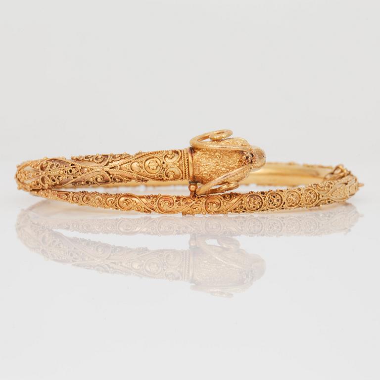 An etruscan revival rams head gold bangle.