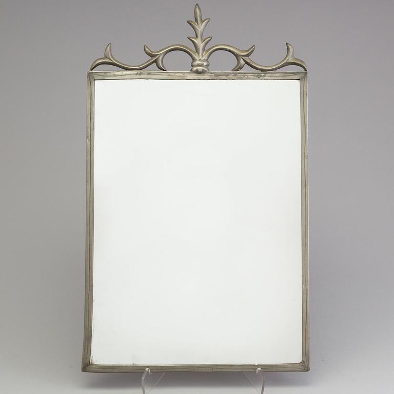 a pewter mirror dated 1930.