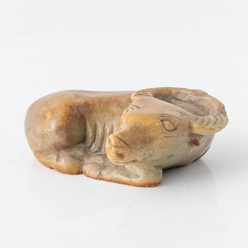 A carved Chinese sculpture of a reclining ox, 20th Century or older.