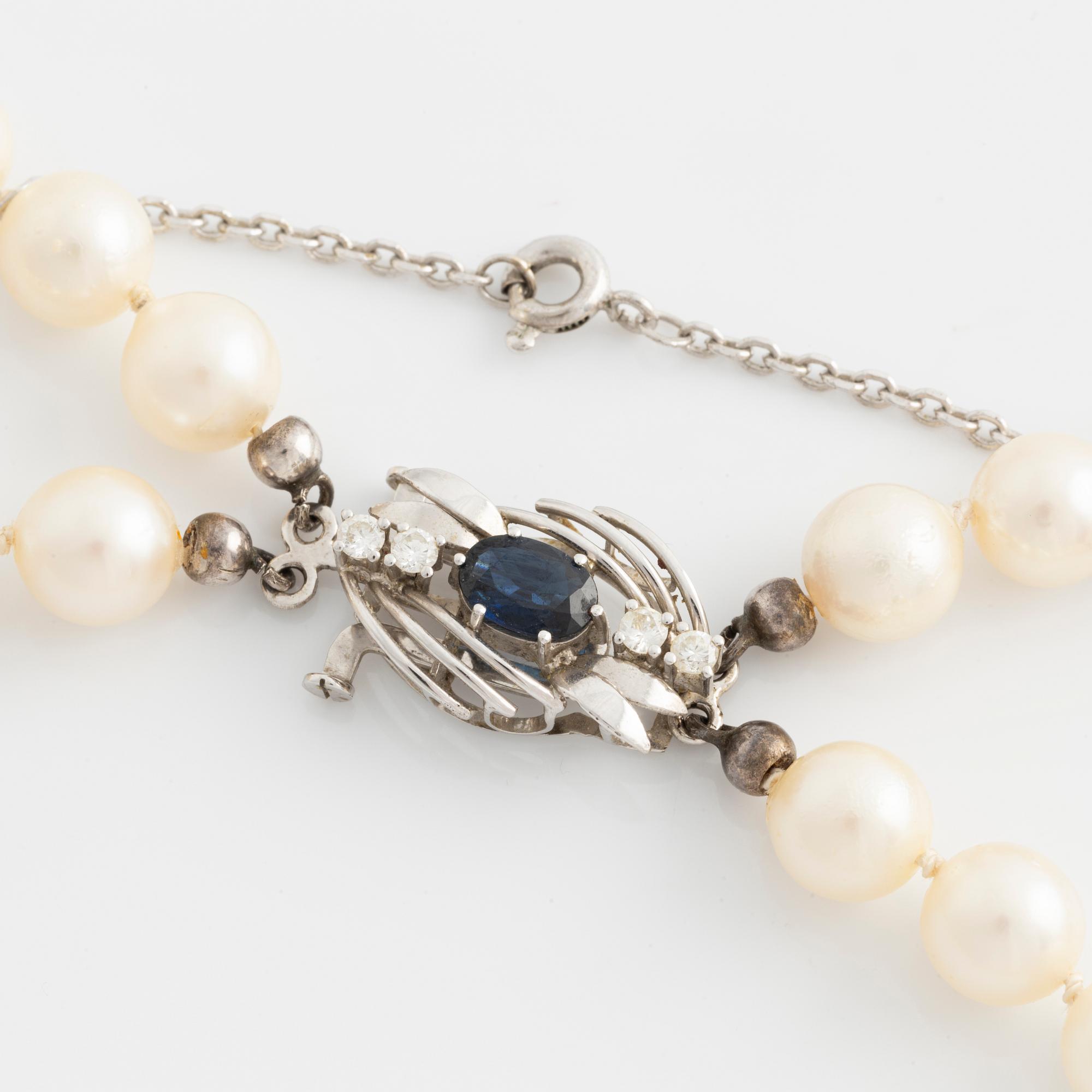 Necklace, double-stranded, cultured pearls, white gold clasp with sapphire and brilliant-cut diamonds.