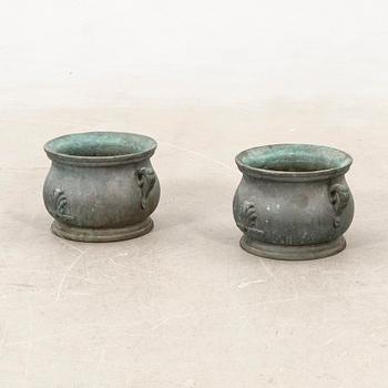 Outer casings/urns, a pair from the first half of the 20th century, cast iron.