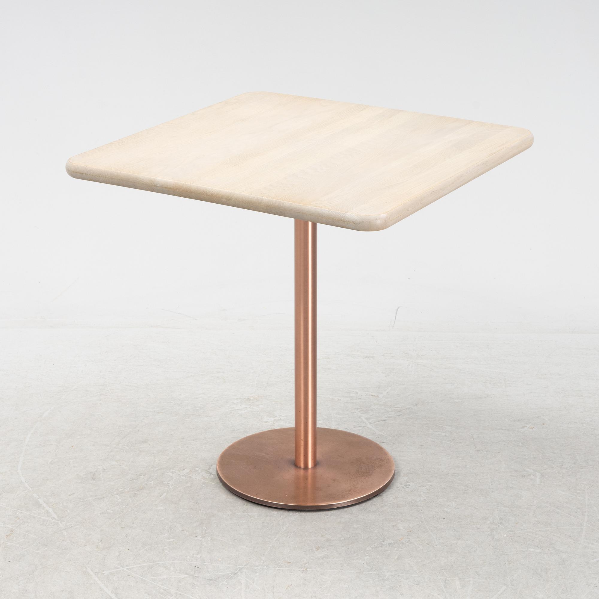 A steel and oak table by Jonas Lindvall 2011.