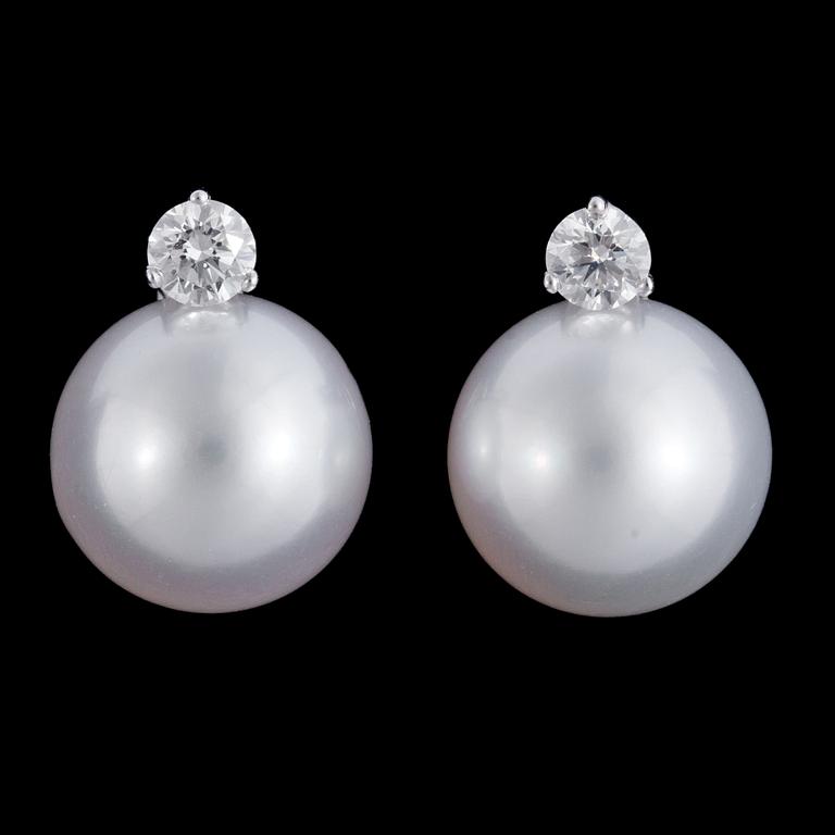 A pair of cultured South sea pearl, 13,3 mm, and diamond earrings, tot. 0.60 cts.